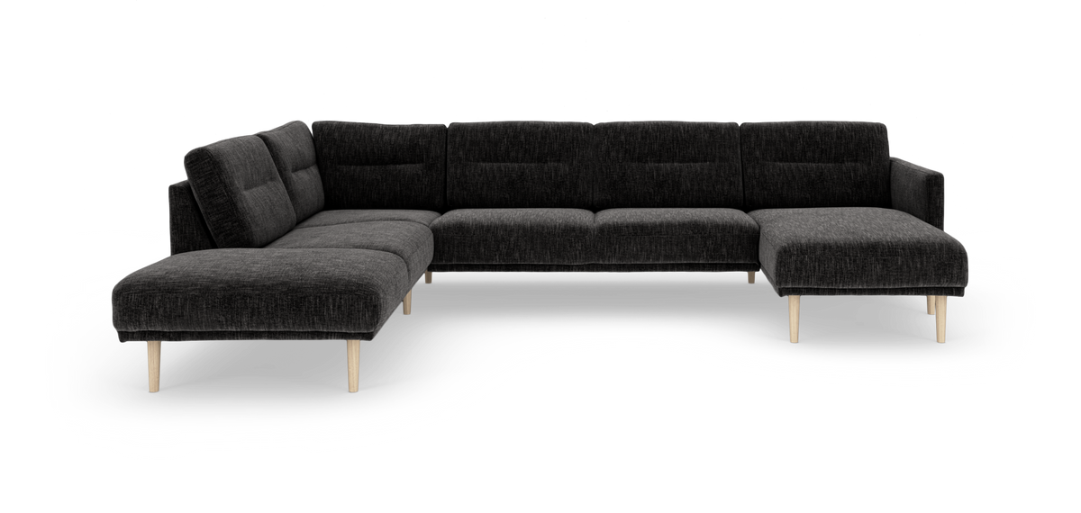 Mørkegrå modulsofa i hjørneudgave med chaiselong til højre og lyse træben, frilagt på hvid baggrund.