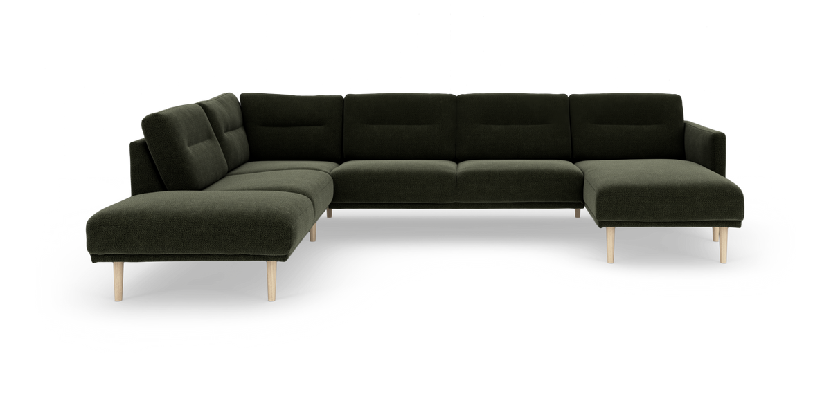 Mørkegrøn modul-hjørnesofa med chaiselong til højre og lyse træben, frilagt på hvid baggrund.