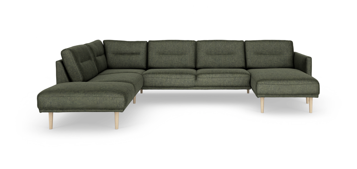 Grøn modulopbygget hjørnesofa med chaiselong og lyse træben, frilagt på hvid baggrund.