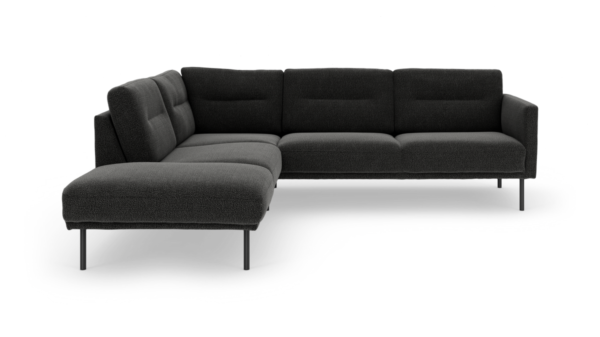 Mørkegrå L‑sofa med chaiselong, polstrede ryglæn og slanke metalben, frilagt mod hvid baggrund.