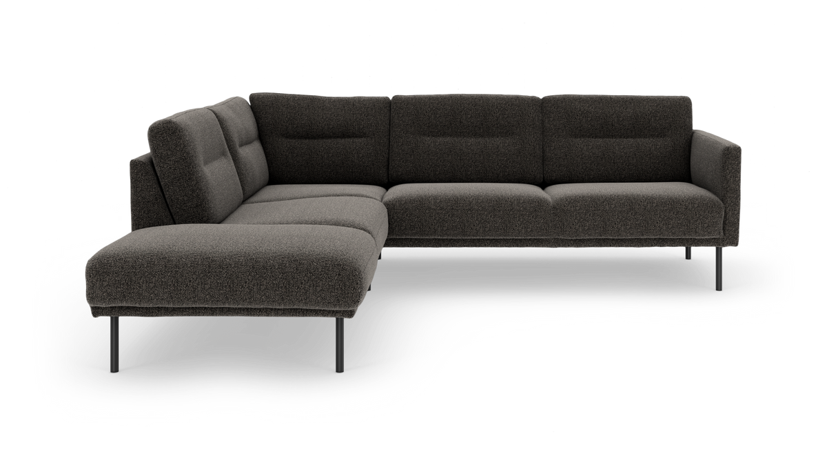 Mørkegrå L-formet modulsofa med chaiselong til venstre på slanke metalben, frilagt.
