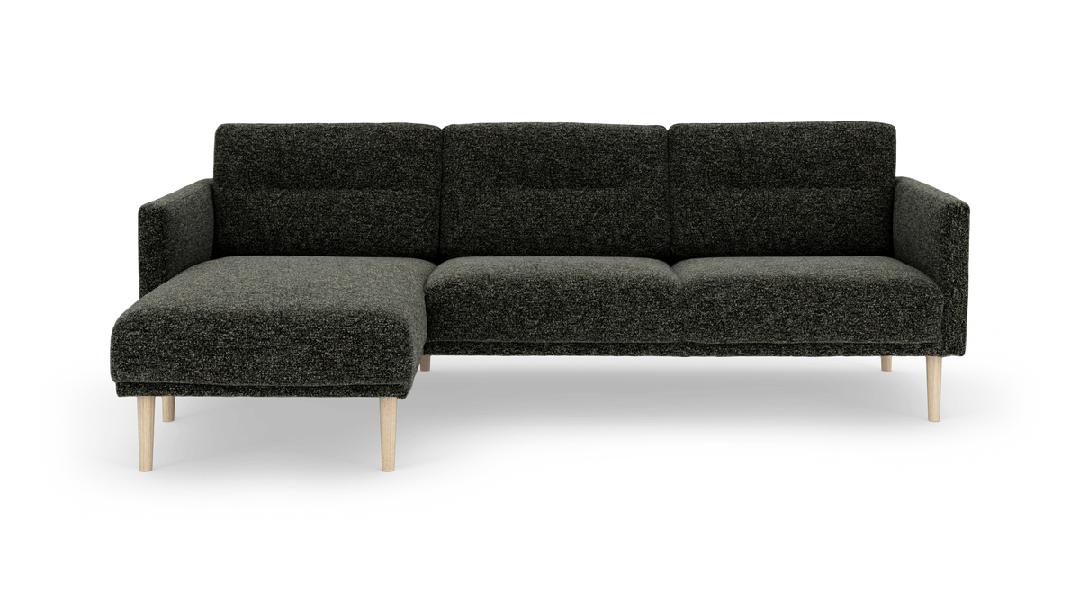 Mørkegrå modulsofa med venstrevendt chaiselong og lyse træben, frilagt på hvid baggrund.
