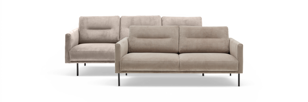 Beige sofasæt i fløjl, 3-pers. foran og 2-pers. bagved, frilagt mod hvid baggrund.