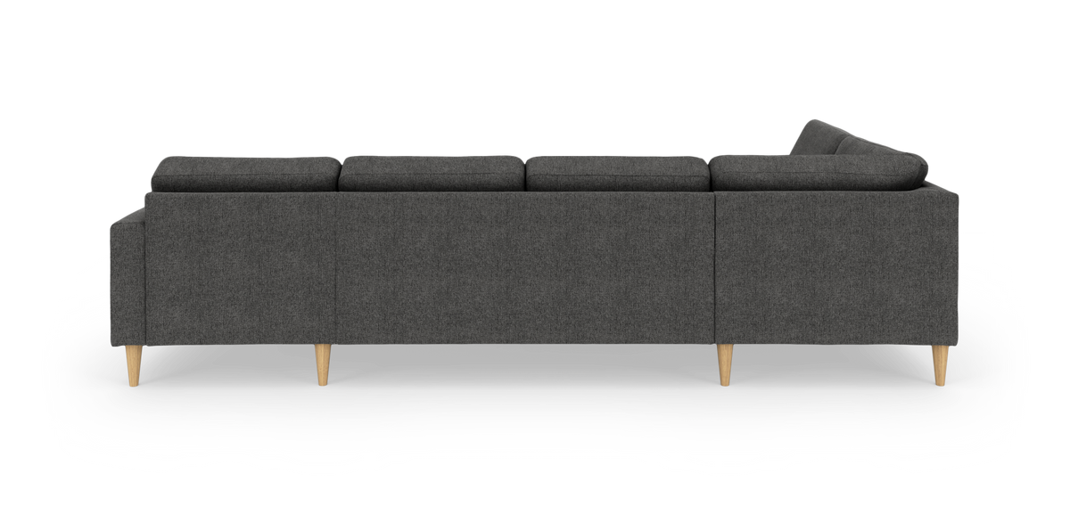 Mørkegrå sofa med træben set bagfra på hvid baggrund.