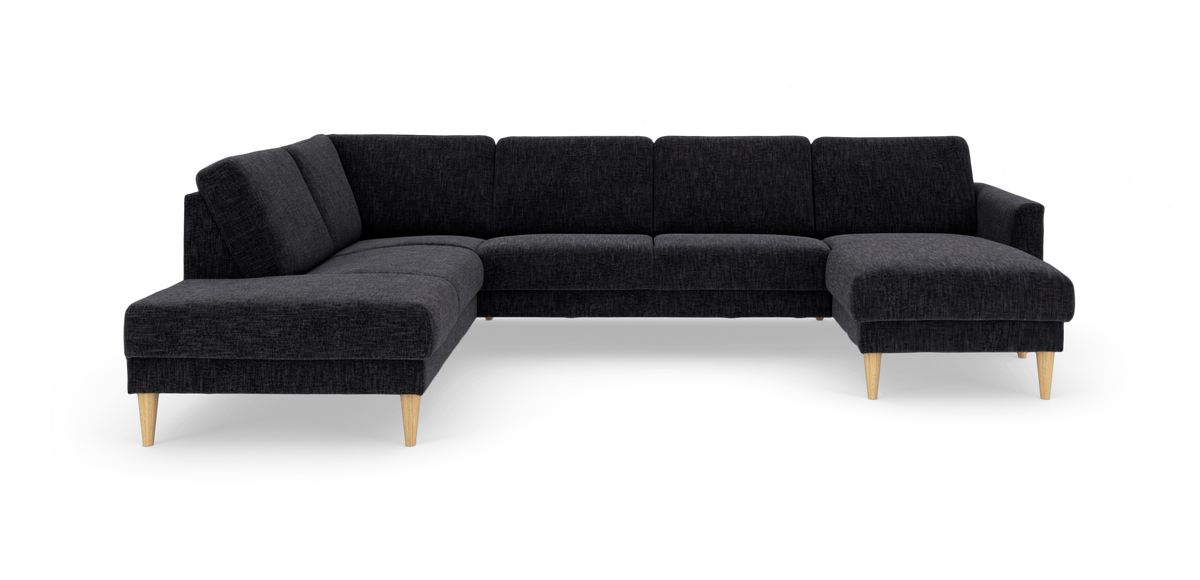 Mørkegrå modulhjørnesofa med chaiselong til højre og lyse træben, frilagt på hvid baggrund.
