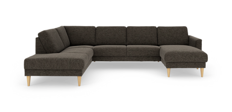 Mørkegrå hjørnesofa med chaiselong til højre og lyse træben.