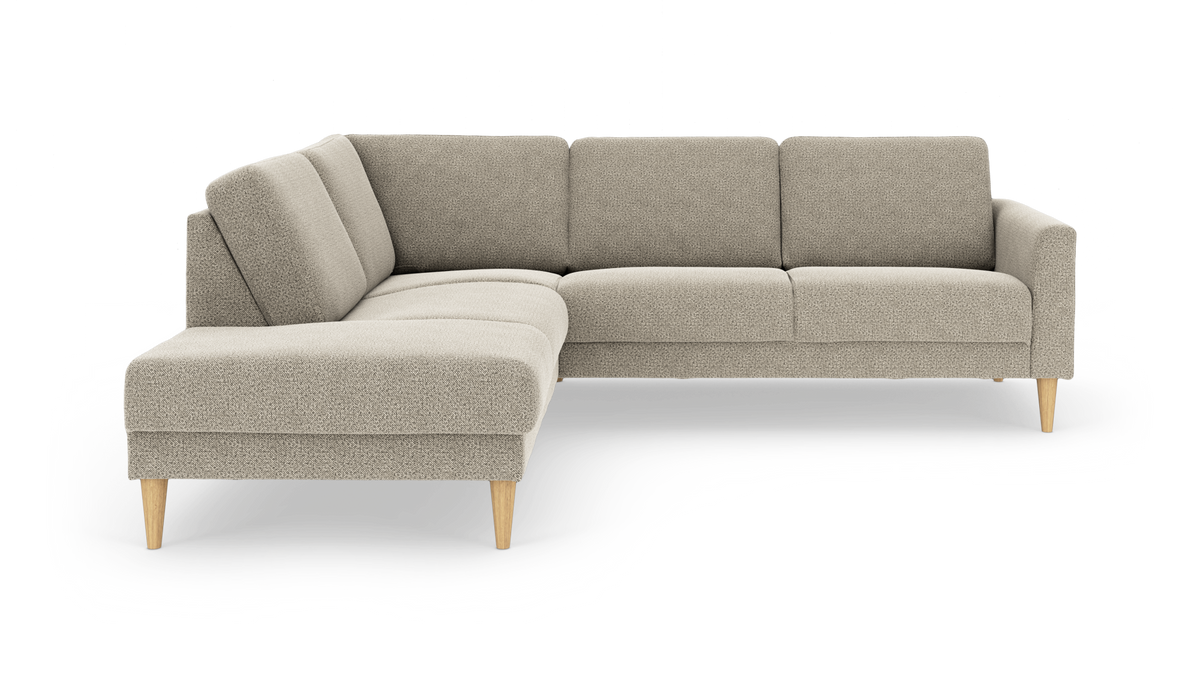L-formet hjørnesofa i lys beige stof med venstrevendt chaiselong og koniske ben i lyst træ.
