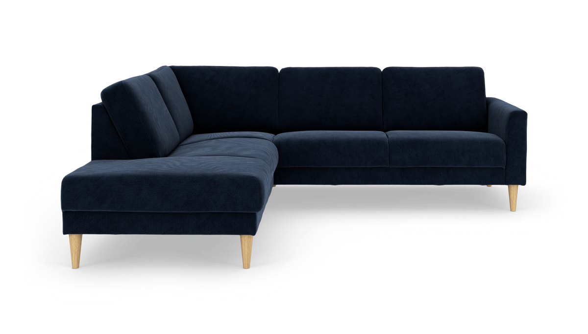 Mørkeblå L‑sofa med chaiselong og lyse træben, fritlagt på hvid baggrund.