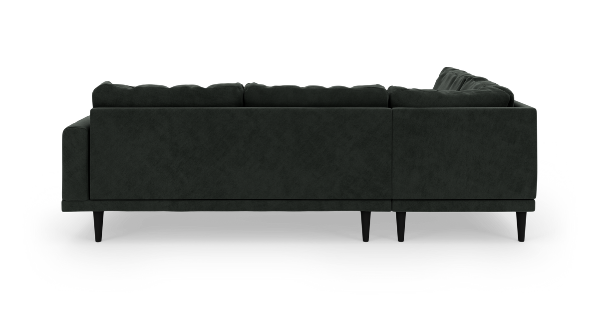Mørkegrøn modulsofa set bagfra på hvid baggrund.