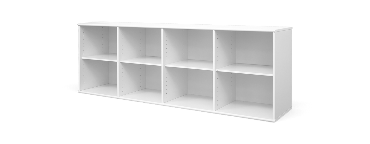 Lys skandinavisk stue med beige sofa, runde sofaborde i træ, hvidt tæppe, planter, vægkunst og gulvlampe ved stort vindue med lette gardiner.