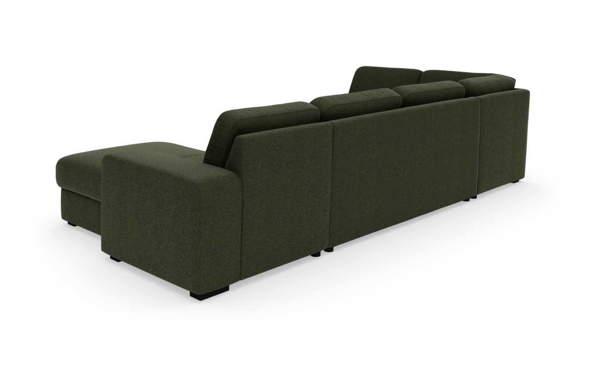 Mørkegrøn modulsofa med chaiselong set bagfra på hvid studiebaggrund.