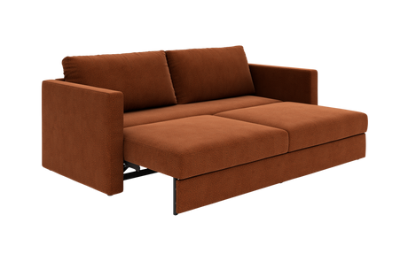 Rustfarvet sovesofa med to ryghynder, trukket ud i sengeleje.