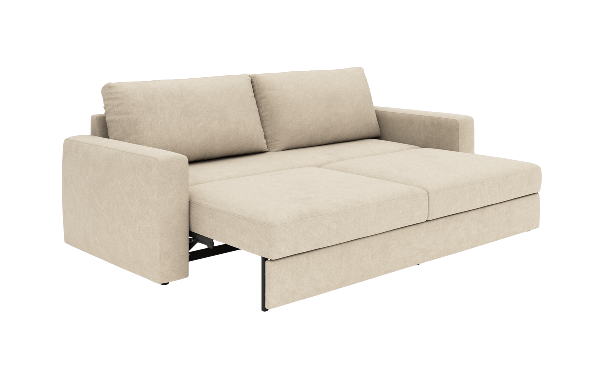 Beige sovesofa i stof, slået ud til seng med to ryghynder.