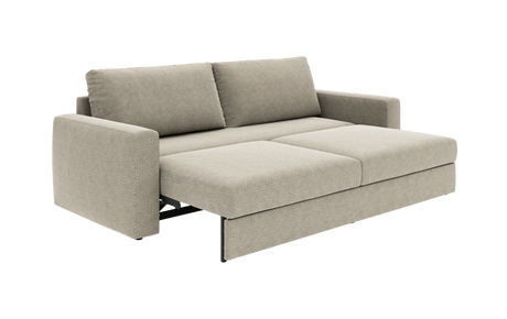Beige sovesofa i udslået position med to ryghynder og brede armlæn, frilagt på hvid baggrund.