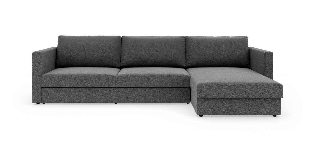 Mørkegrå modulsofa med chaiselong på højre side, set forfra i studio.