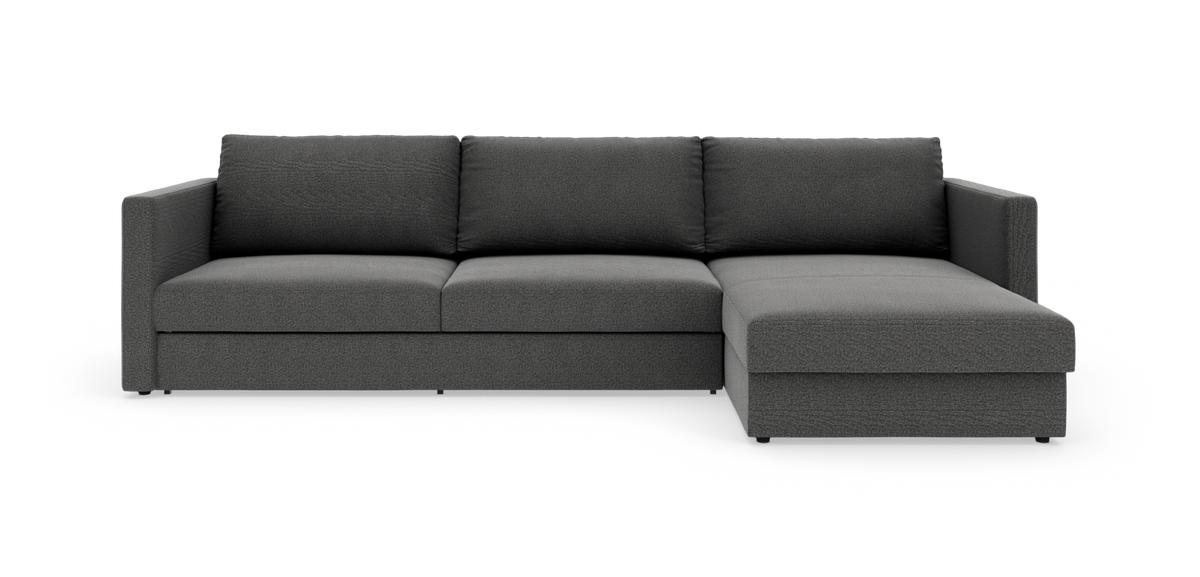 Mørkegrå L‑sofa med højre chaiselong, fotograferet i studie på hvid baggrund.