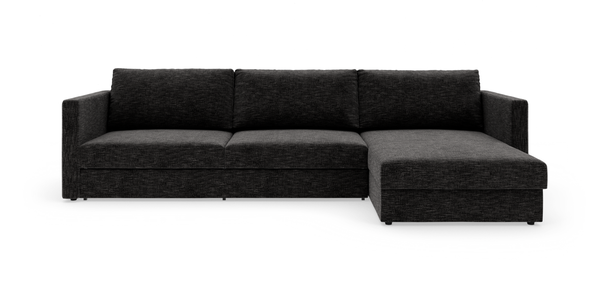 Mørkegrå modulsofa med chaiselong i højre side, fotograferet lige forfra på hvid studiobaggrund.