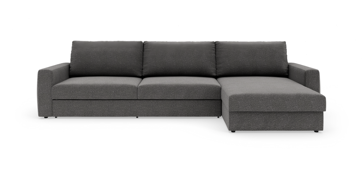 Mørkegrå modulsofa med chaiselong til højre på hvid studiobaggrund.