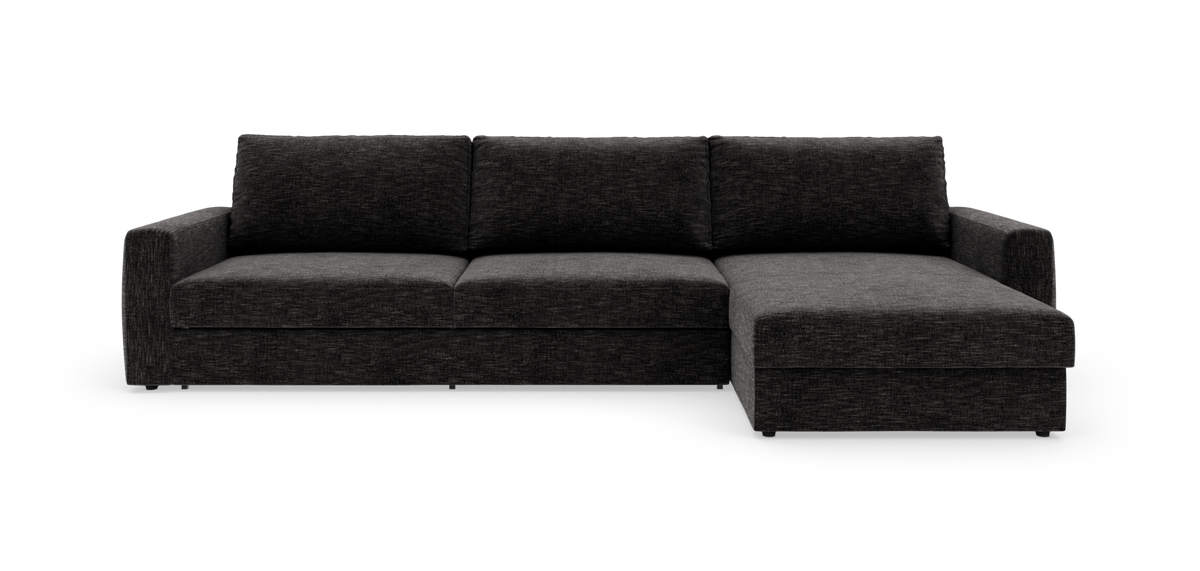 Mørkegrå modulsofa med chaiselong til højre, set forfra mod hvid baggrund.