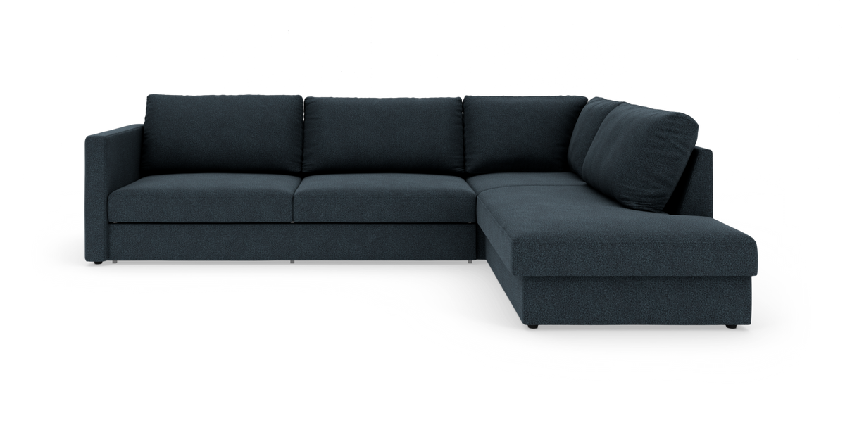 Mørkeblå L‑formet hjørnesofa med højrevendt chaiselong, fritlagt på hvid baggrund.
