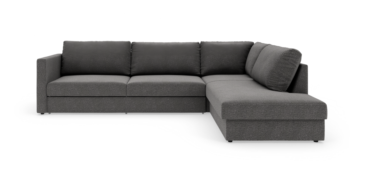 Mørkegrå L-formet modulsofa med chaiselong til højre på hvid baggrund.