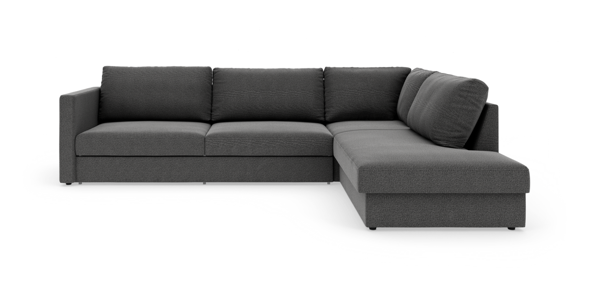 Mørkegrå L‑formet modulsofa med chaiselong til højre, set skråt forfra på hvid baggrund.