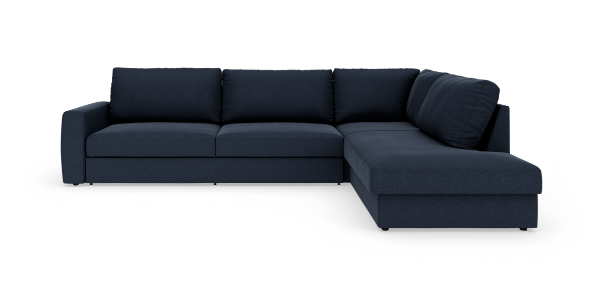 Mørkeblå hjørnesofa med chaiselong til højre, fritlagt på hvid baggrund.