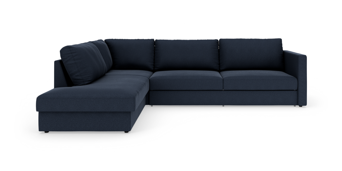Mørkeblå L-sofa med chaiselong til venstre på hvid studiebaggrund.