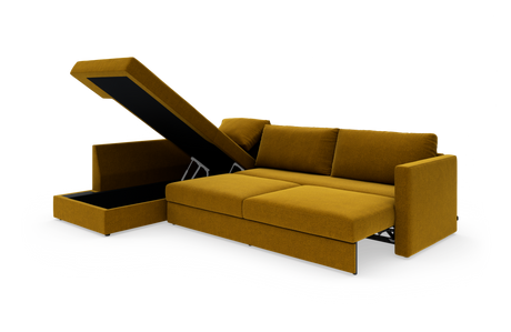 Sennepsgul sovesofa med chaiselong og opklappeligt opbevaringsrum, vist i studiemiljø.