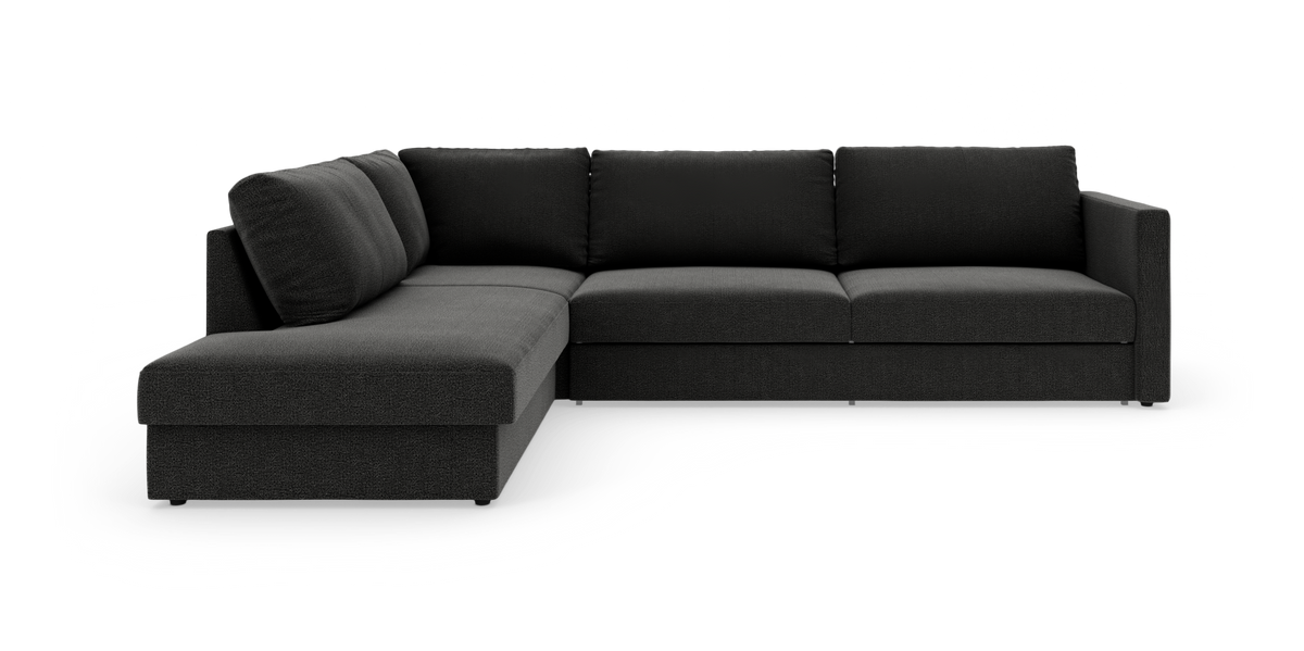 Mørkegrå L‑sofa med chaiselong til venstre, fotograferet i studie mod hvid baggrund.
