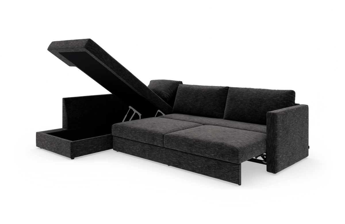Mørkegrå sovesofa med chaiselong og åbent opbevaringsrum, vist i 3/4‑vinkel på hvid baggrund.
