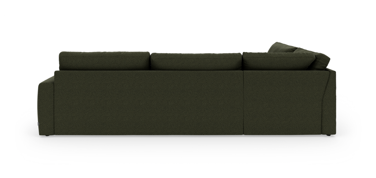Mørkegrøn modulsofa set lige bagfra mod hvid studiobaggrund.