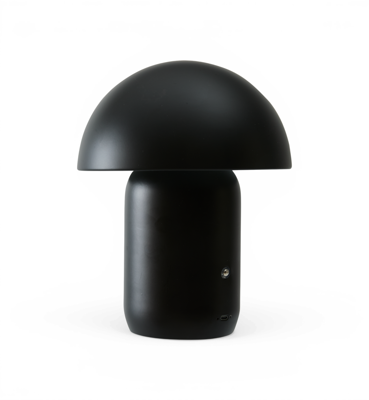 Sort svampeformet bord-/bærbar lampe med knap og USB‑ladeport.