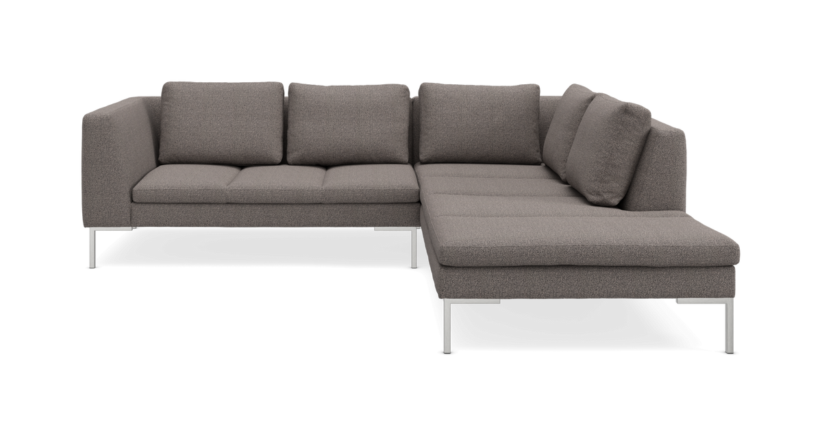 Grå L‑formet sofa med chaiselong og metalben, produktfoto i studie.