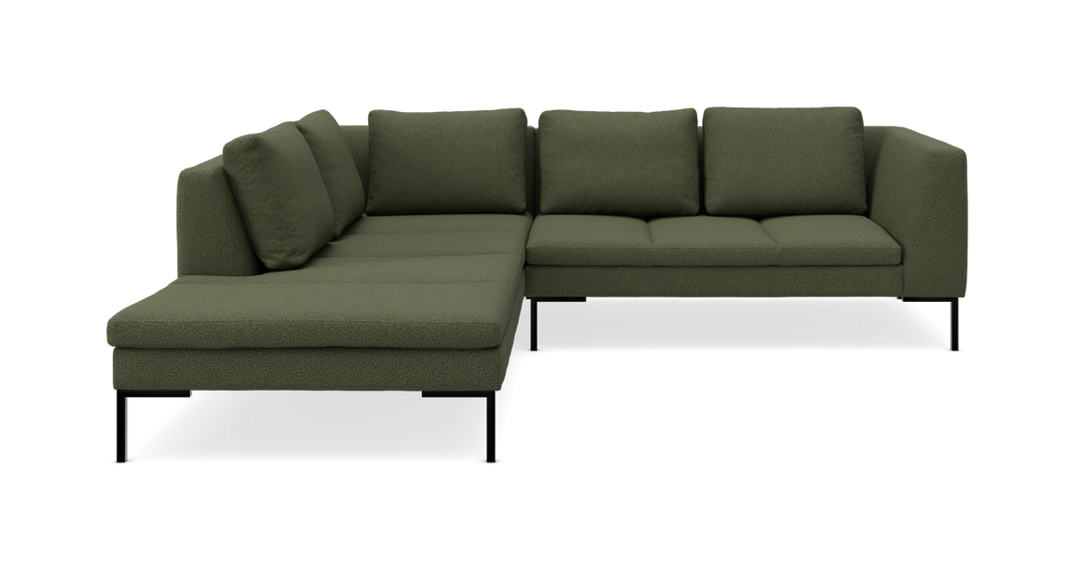 Grøn L-formet modulsofa med chaiselong og sorte metalben.