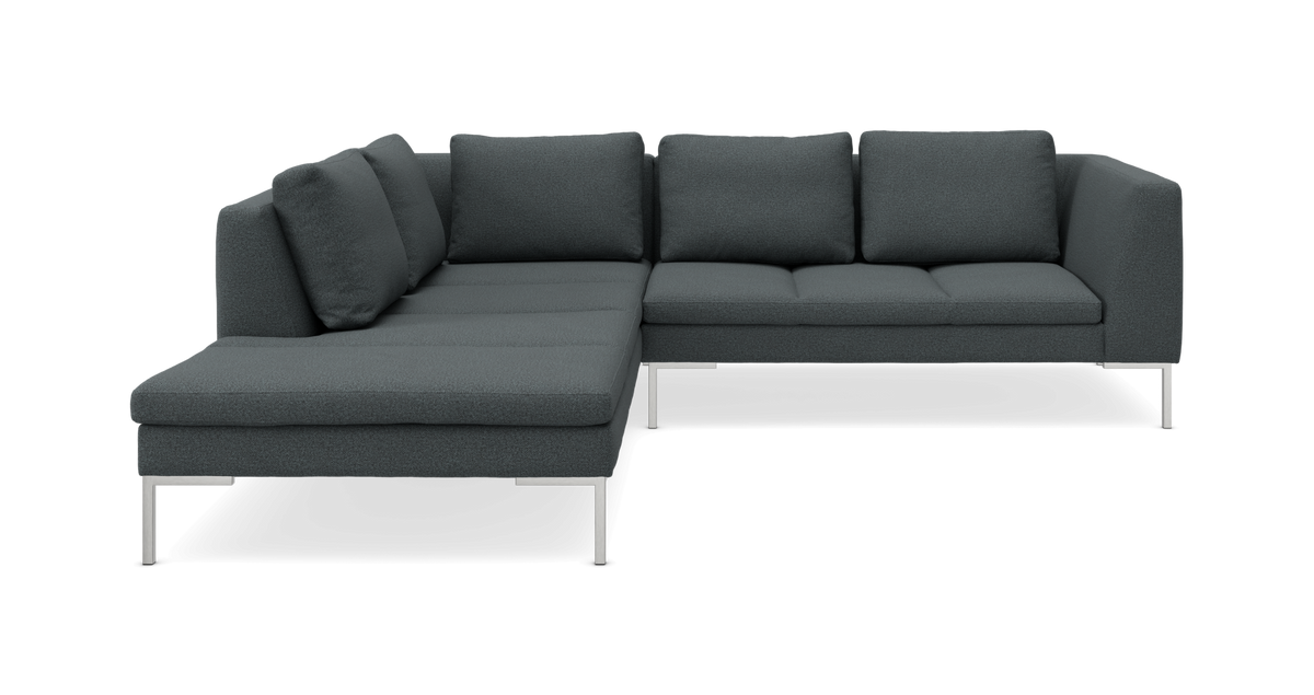 Mørkegrå L-formet modulsofa med metalben, studiebillede.