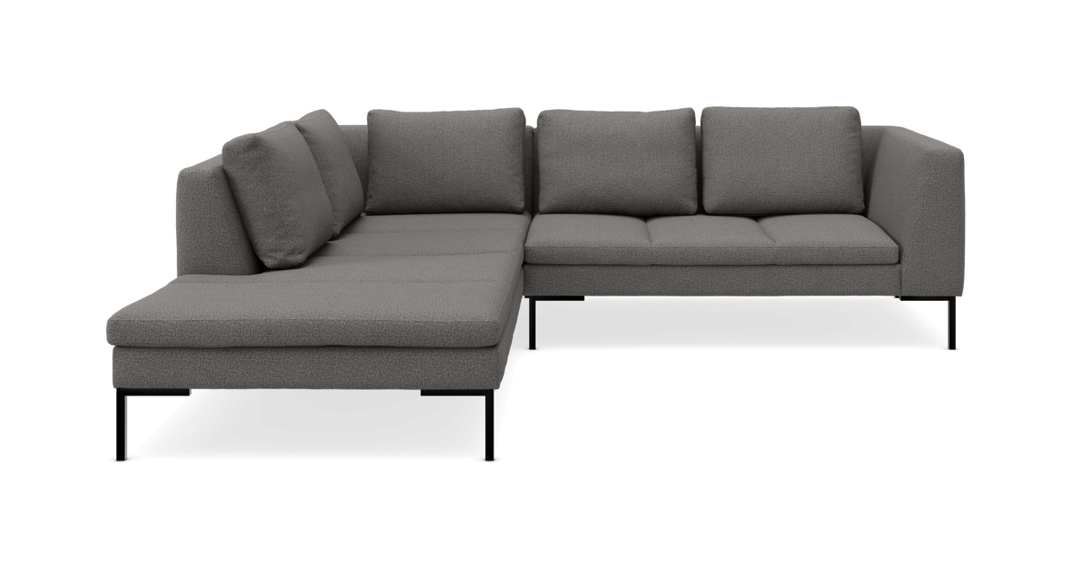 Grå L‑formet modulsofa med chaiselong og bløde ryghynder.