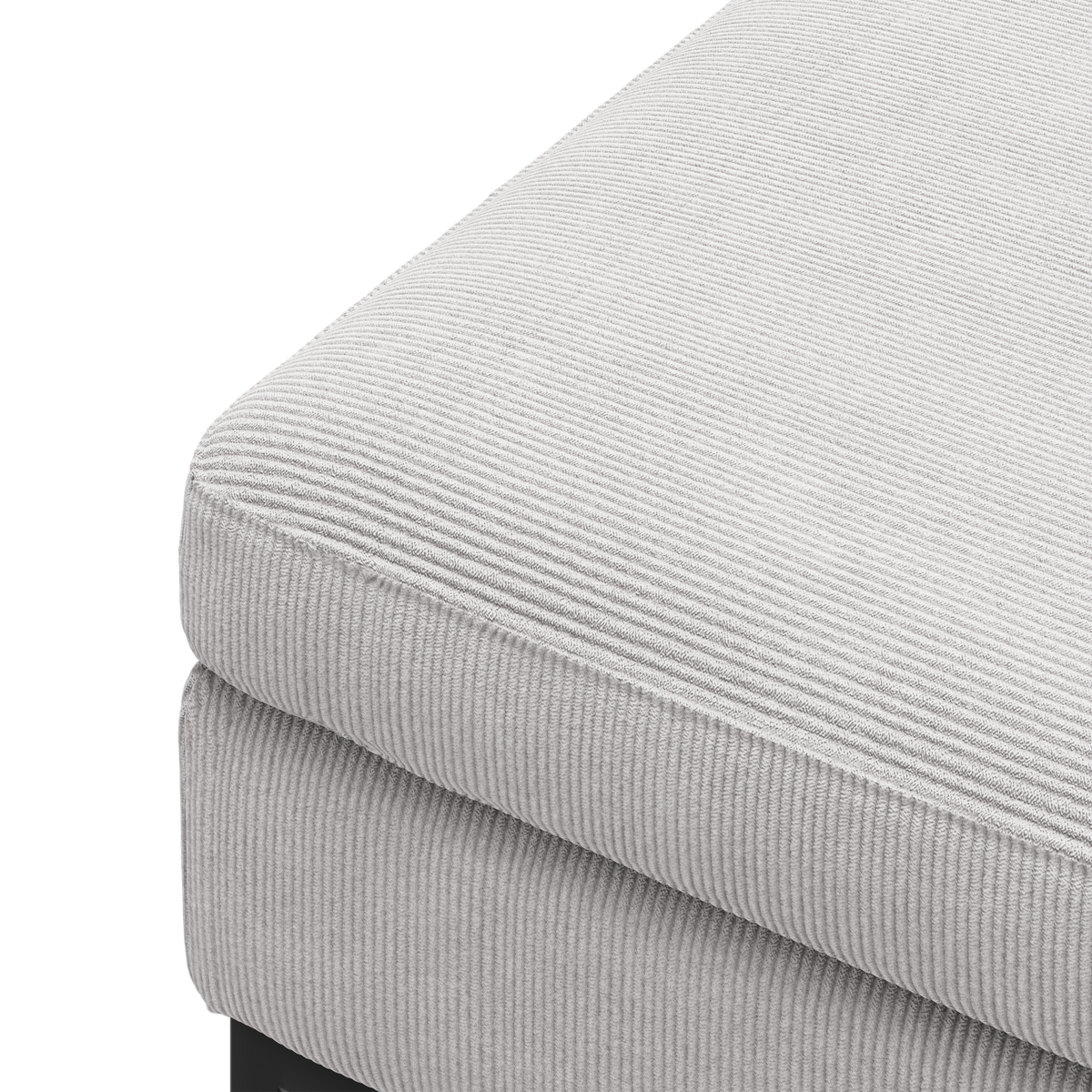 Nærbillede af et lysegråt rillet sofa-sæde i hjørnet med sort ben, frilagt mod hvid baggrund.