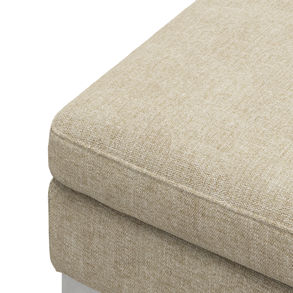 Nærbillede af beige stofbetrukket sofahynde i et hjørne med en tekstureret, bouclé‑lignende overflade.