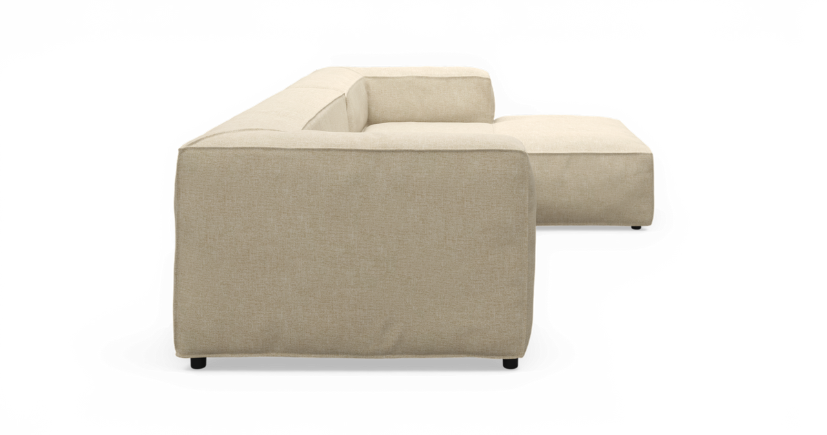 Beige L‑formet modulsofa set fra siden på isoleret baggrund.