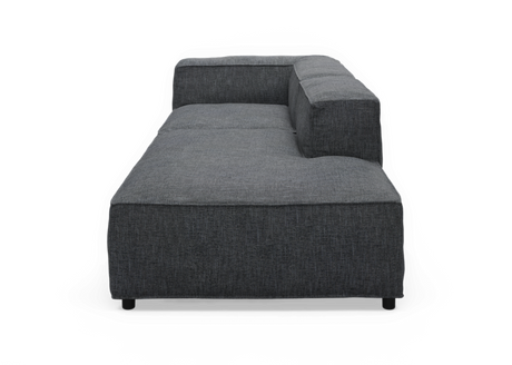 Mørkegrå modulsofa/chaise med høj ryg og højre armlæn, set forfra mod sort baggrund.