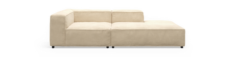 Beige modulsofa med højre chaiselong, frontvisning mod sort baggrund.