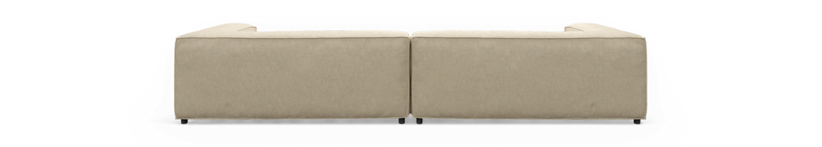 Beige modulsofa set bagfra, frilagt mod sort baggrund.