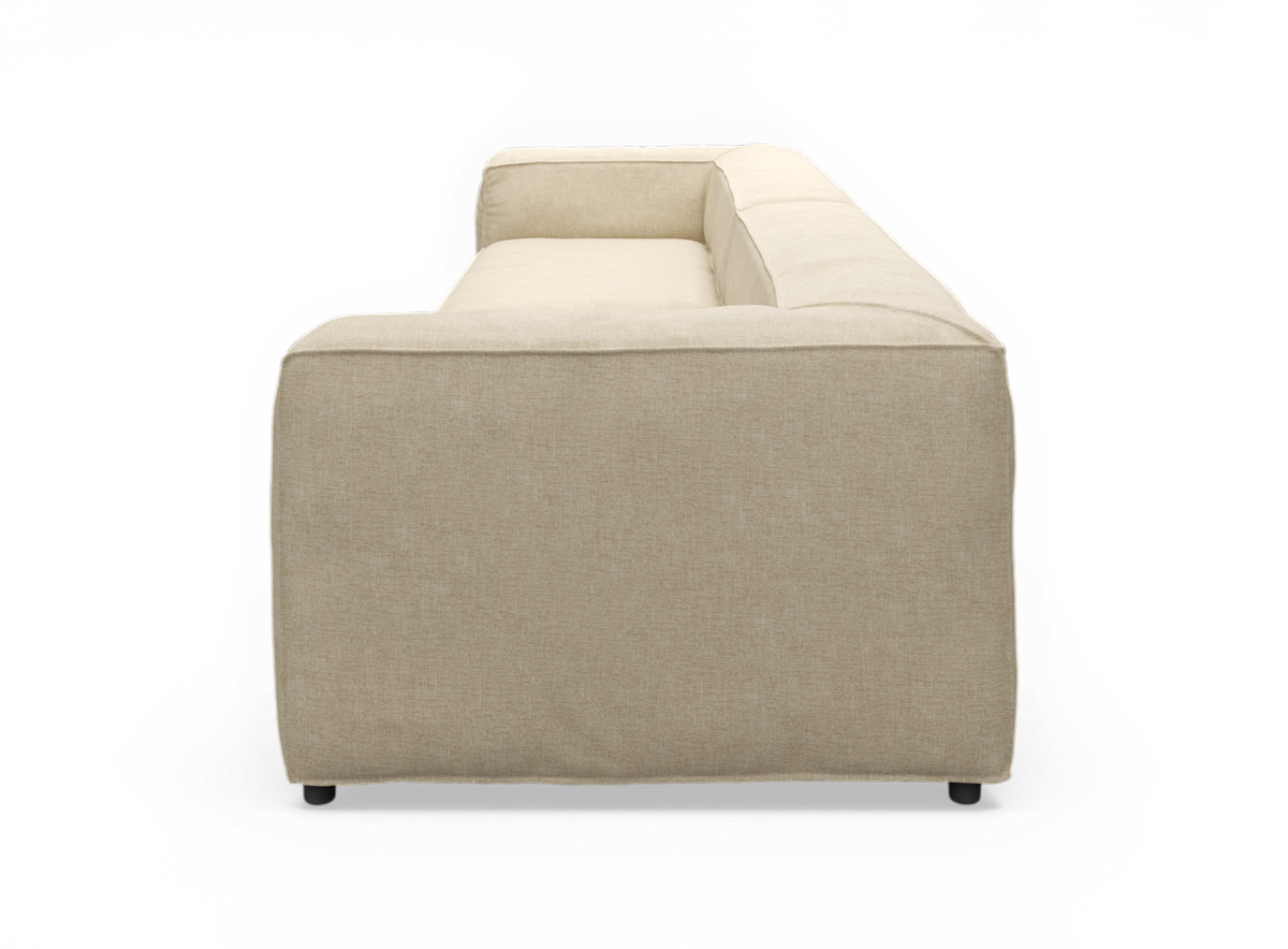 Beige stofsofa/sektion set fra siden, fritlagt mod neutral baggrund.