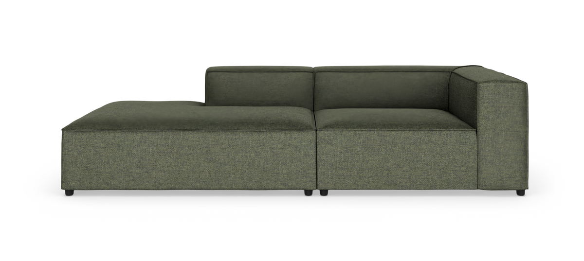 Grøn modulsofa med chaiselong og høj armlæn, fritlagt på hvid baggrund.