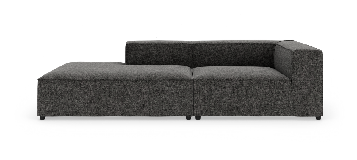 Mørkegrå modulsofa med venstrevendt chaiselong og højre armlæn, fotograferet frontalt på hvid baggrund.