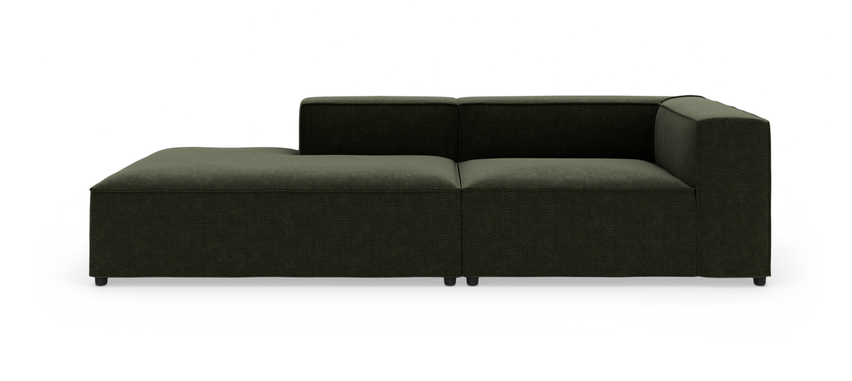 Modulsofa i mørkegrønt stof med venstre chaiselong og højre armlæn, frilagt på hvid baggrund.
