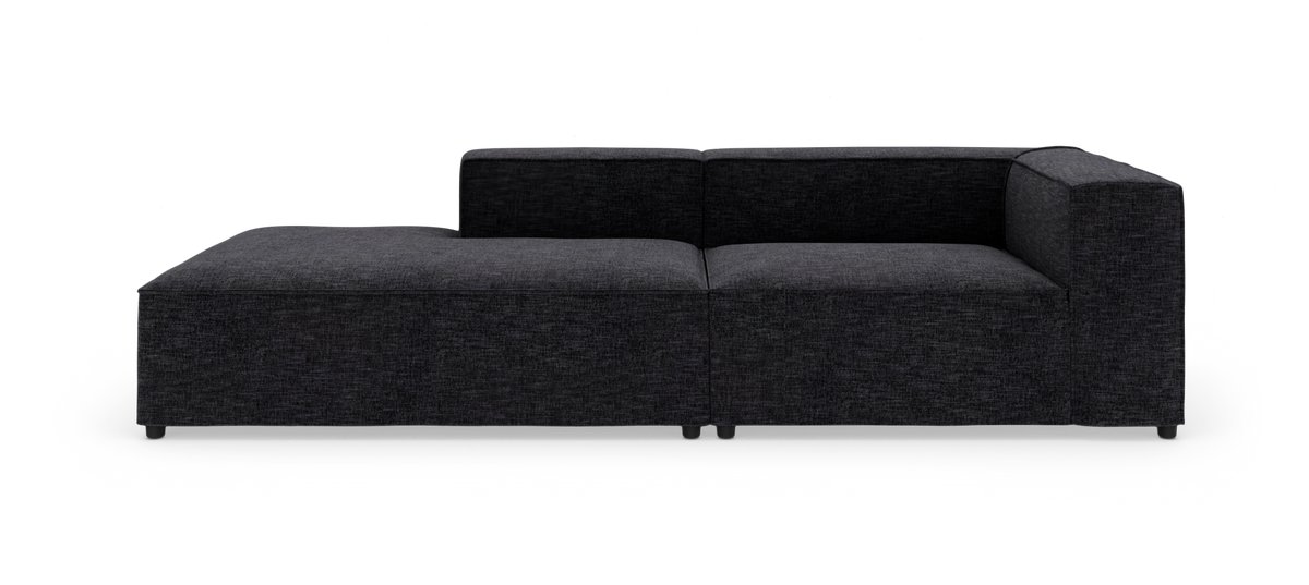 Mørkegrå modulsofa med venstrevendt chaiselong og højre armlæn, fritstående mod hvid baggrund.