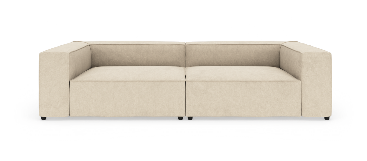 Beige modulsofa med brede armlæn, frilagt på hvid baggrund.