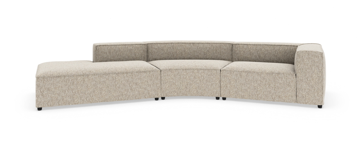 Lys beige modulsofa i buet form med chaiselong til venstre og armlæn til højre, fritstående på hvid baggrund.